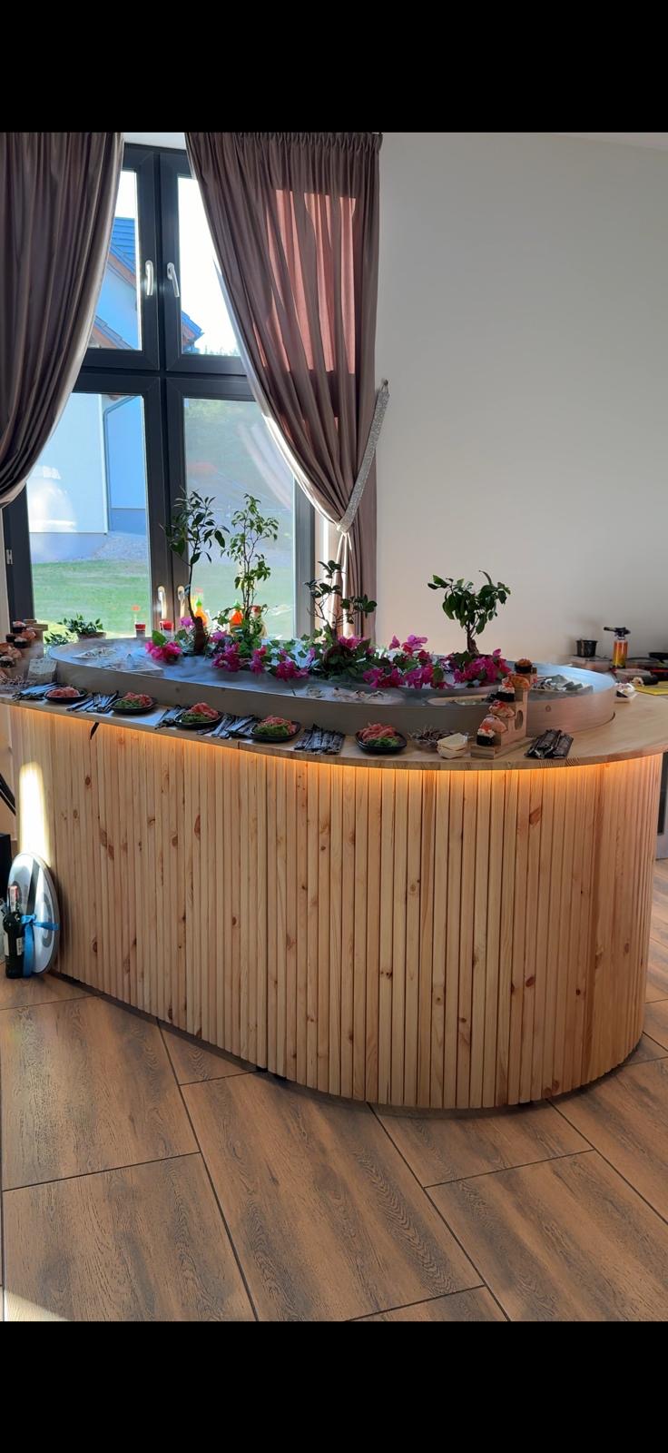 River Table styled at an evening event, flowers on the island