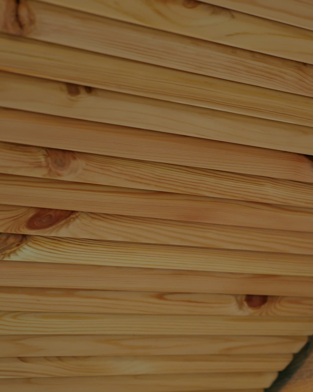 Raw pine slats stacked in the workshop