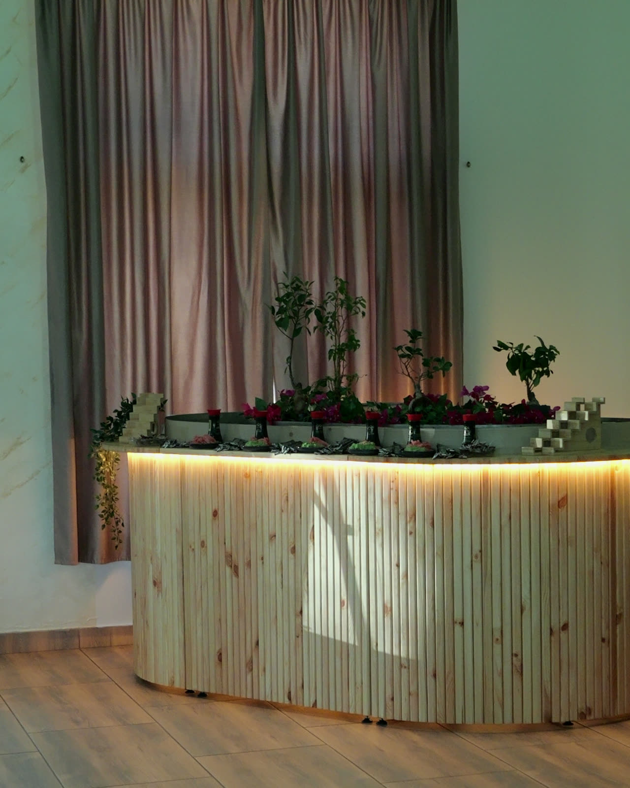 River Table glowing warm under its rim light, styled in a wedding hall